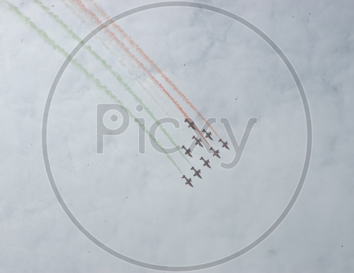 Group of jet planes flying in air with tri-colour art
