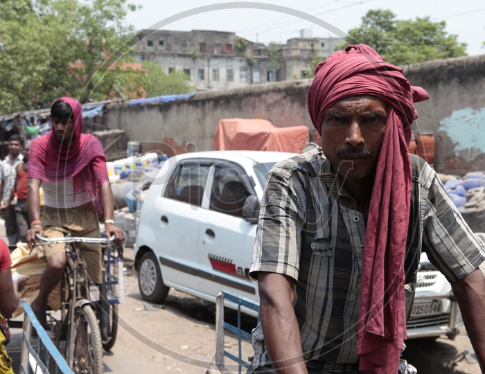 An Indian man peddling rickshaw