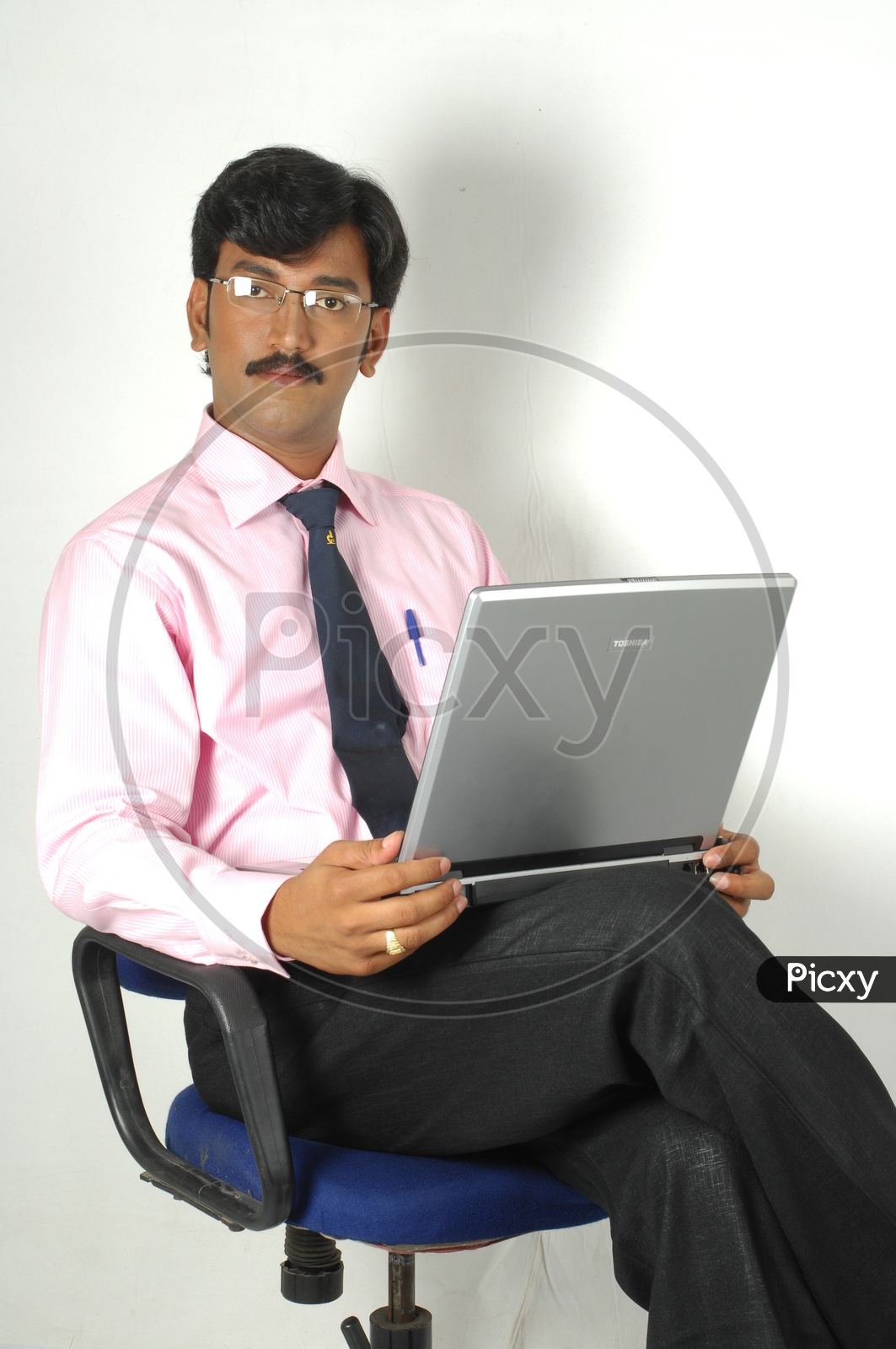 Indian man working infront of a laptop