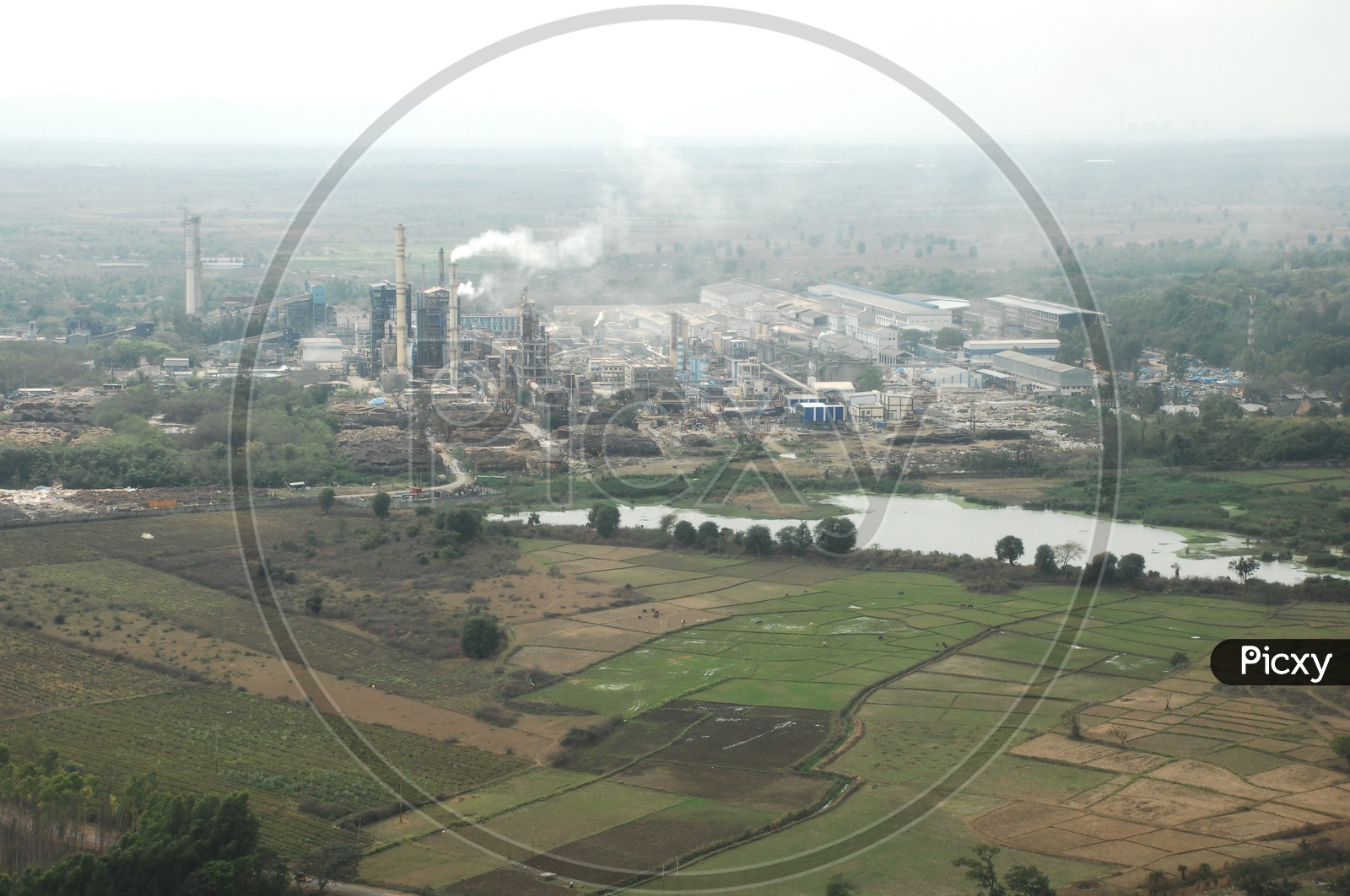 Aerial View of an Industry / Factory with agriculture fields in the foreground