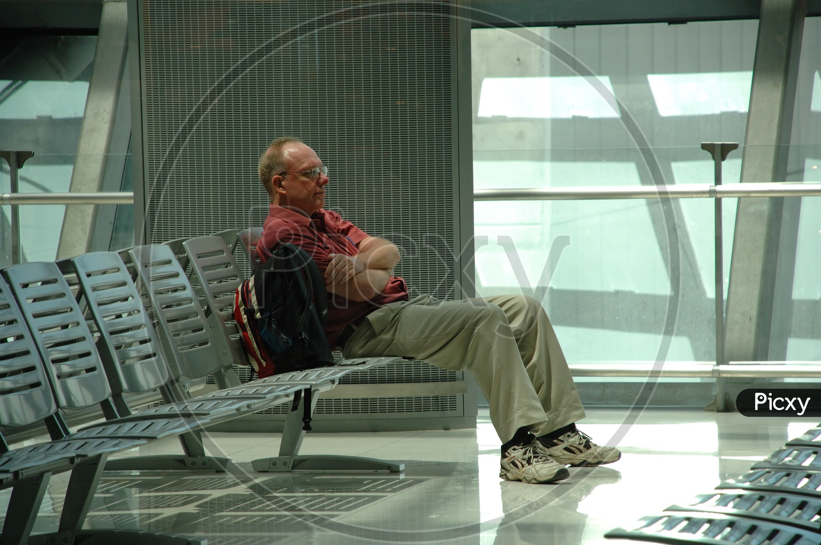An old man waiting at the airport