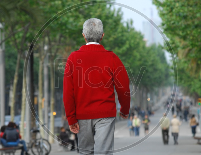 An old man walking on the road