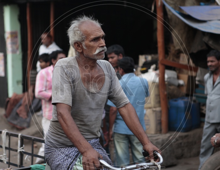 An old man pedaling the rickshaw