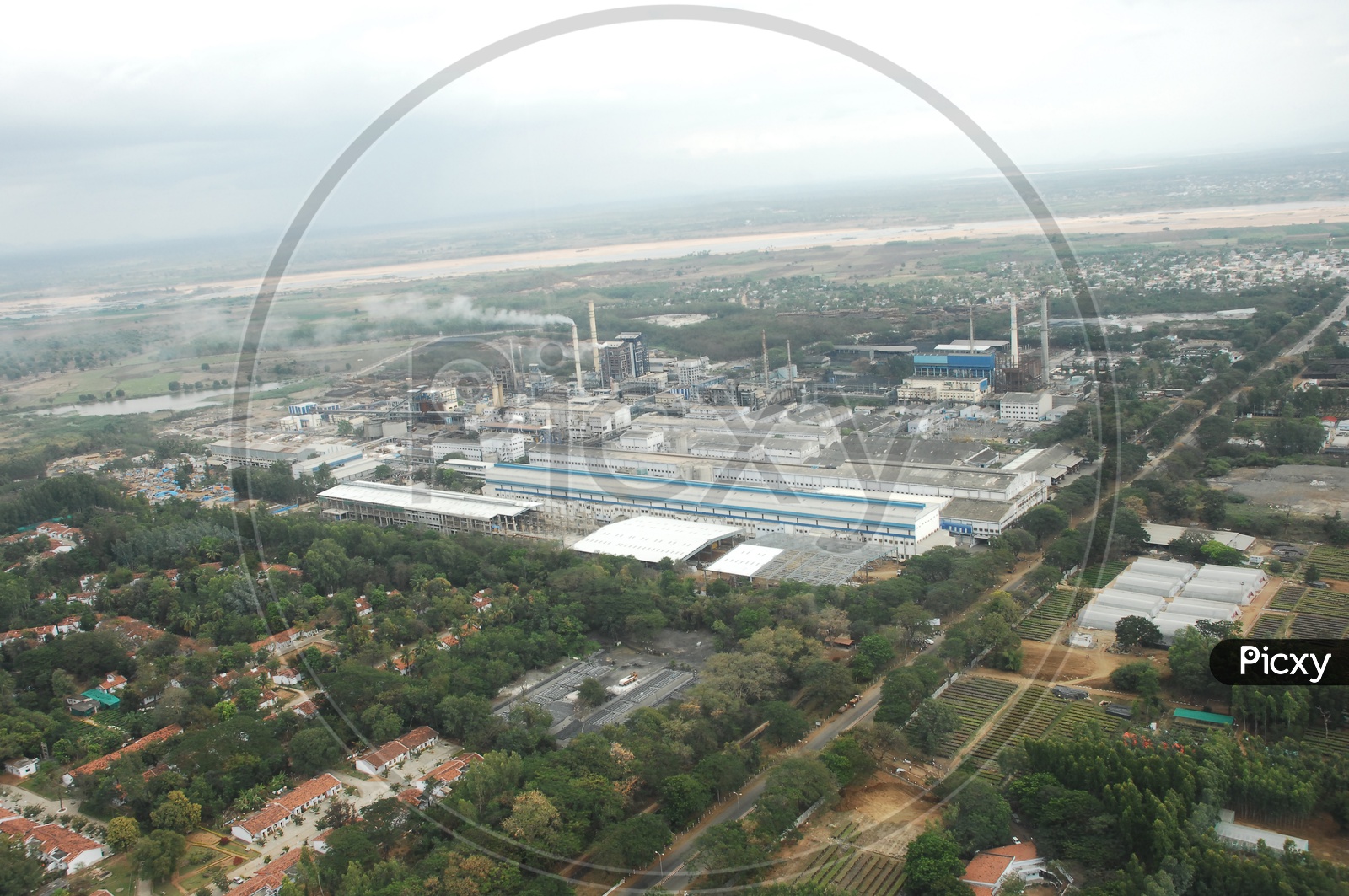 Aerial View Of a Industrial Aerial With Factory  and Exhaust Pipes From Flight Window