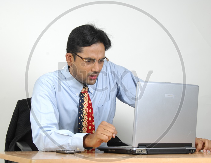 Young Indian Man working on a  Laptop