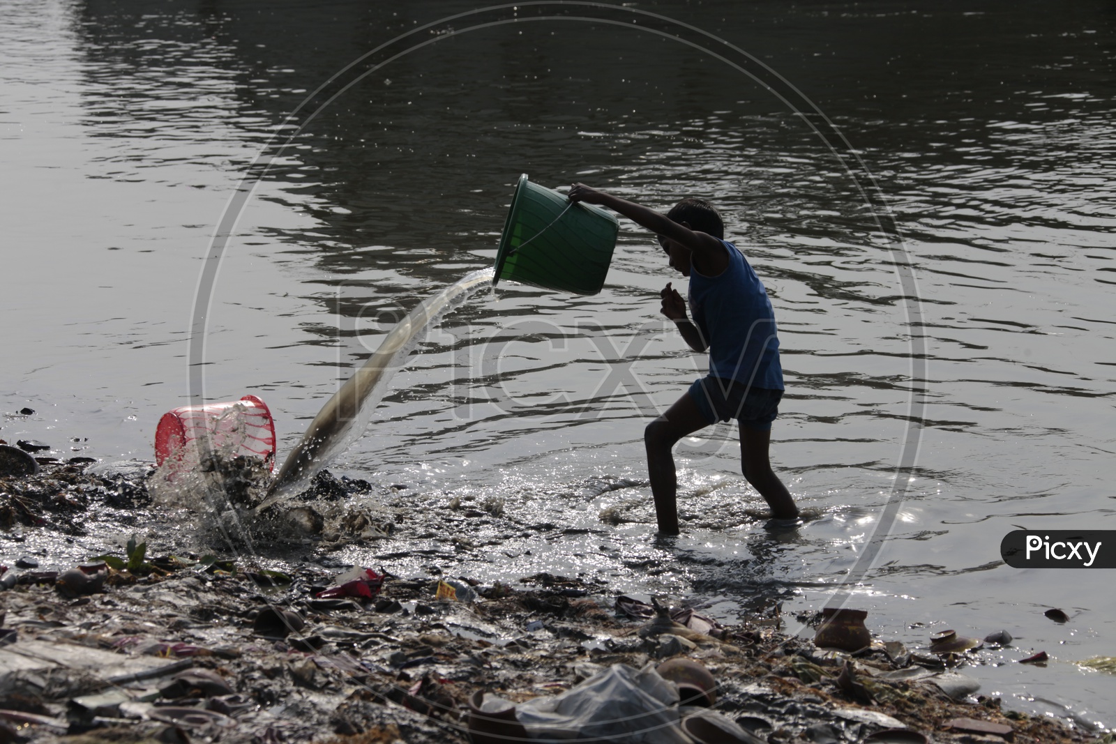 A boy at a dumping garbage at the dump yard