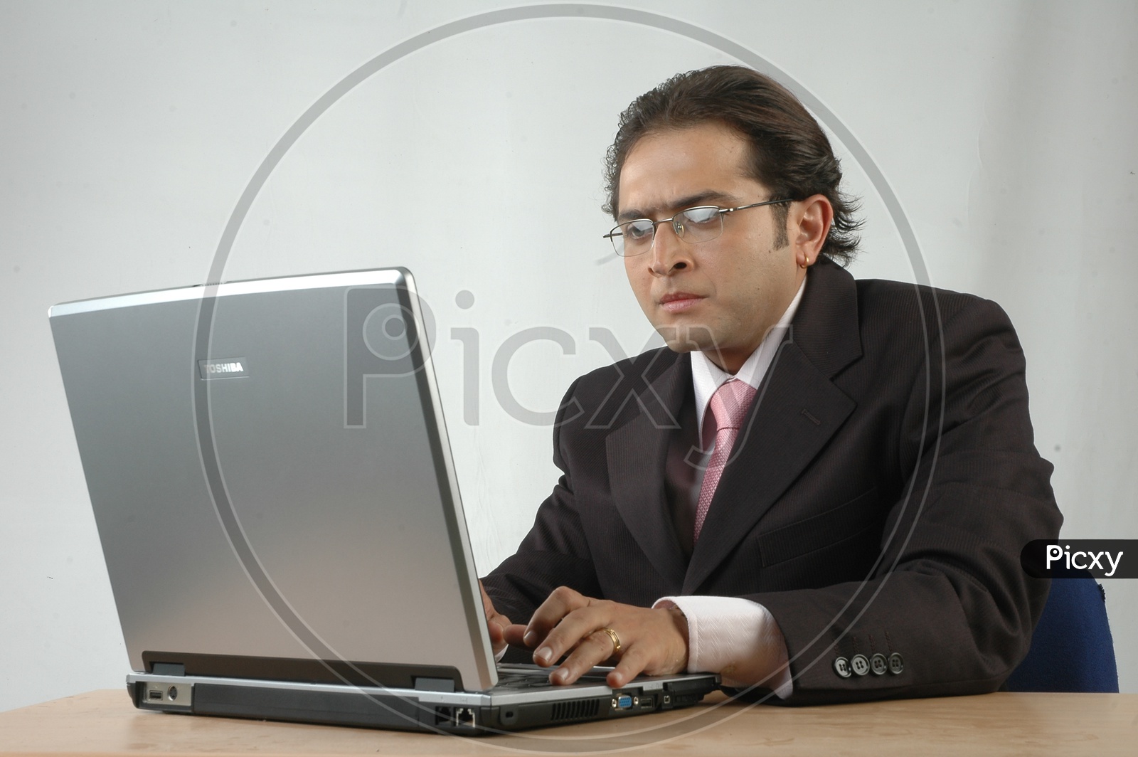 Indian man working with a laptop