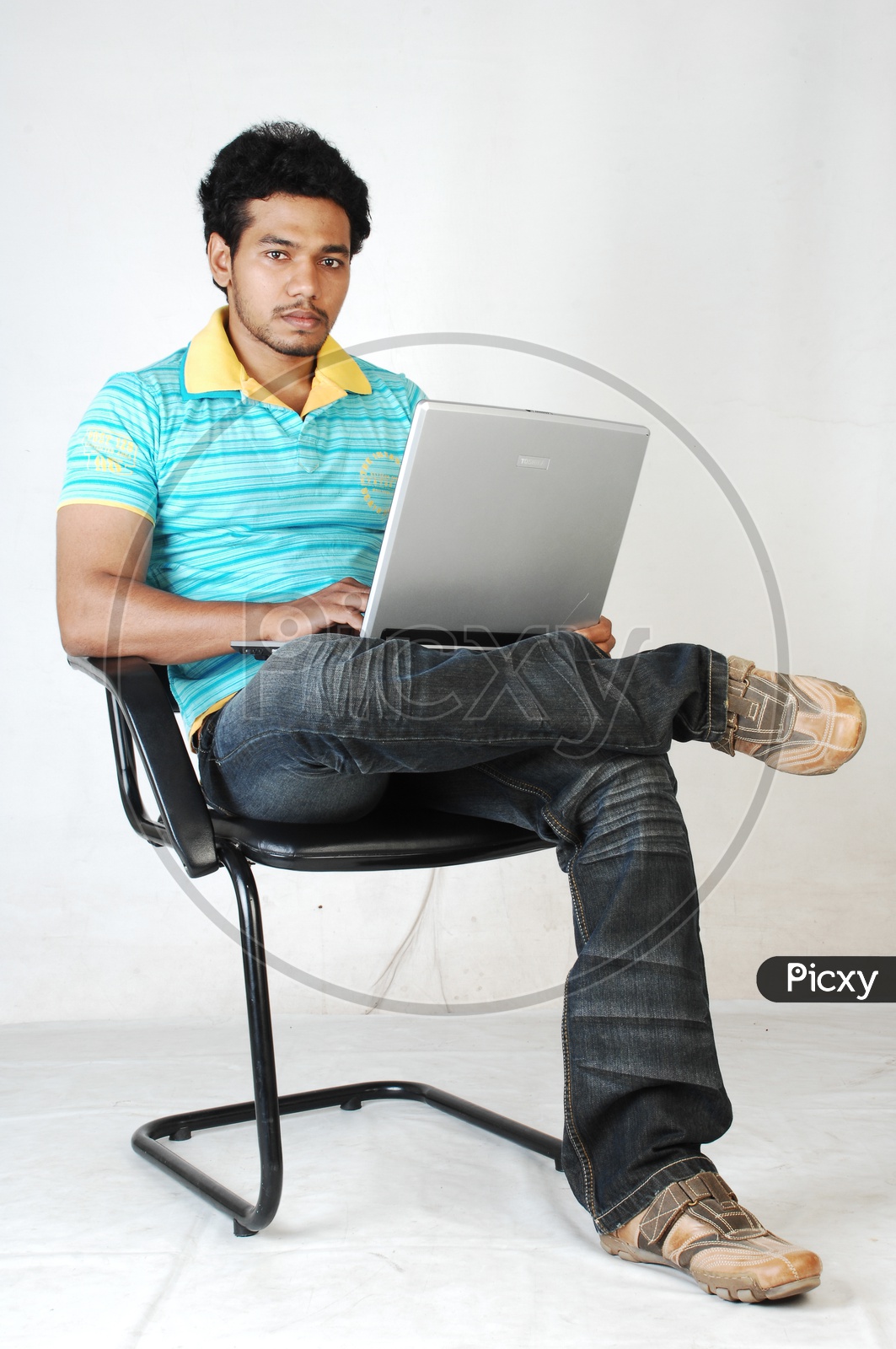 Young indian Student with a laptop