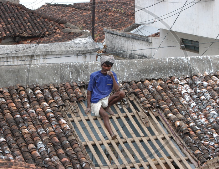A Man Working On His House Roof Ceiling