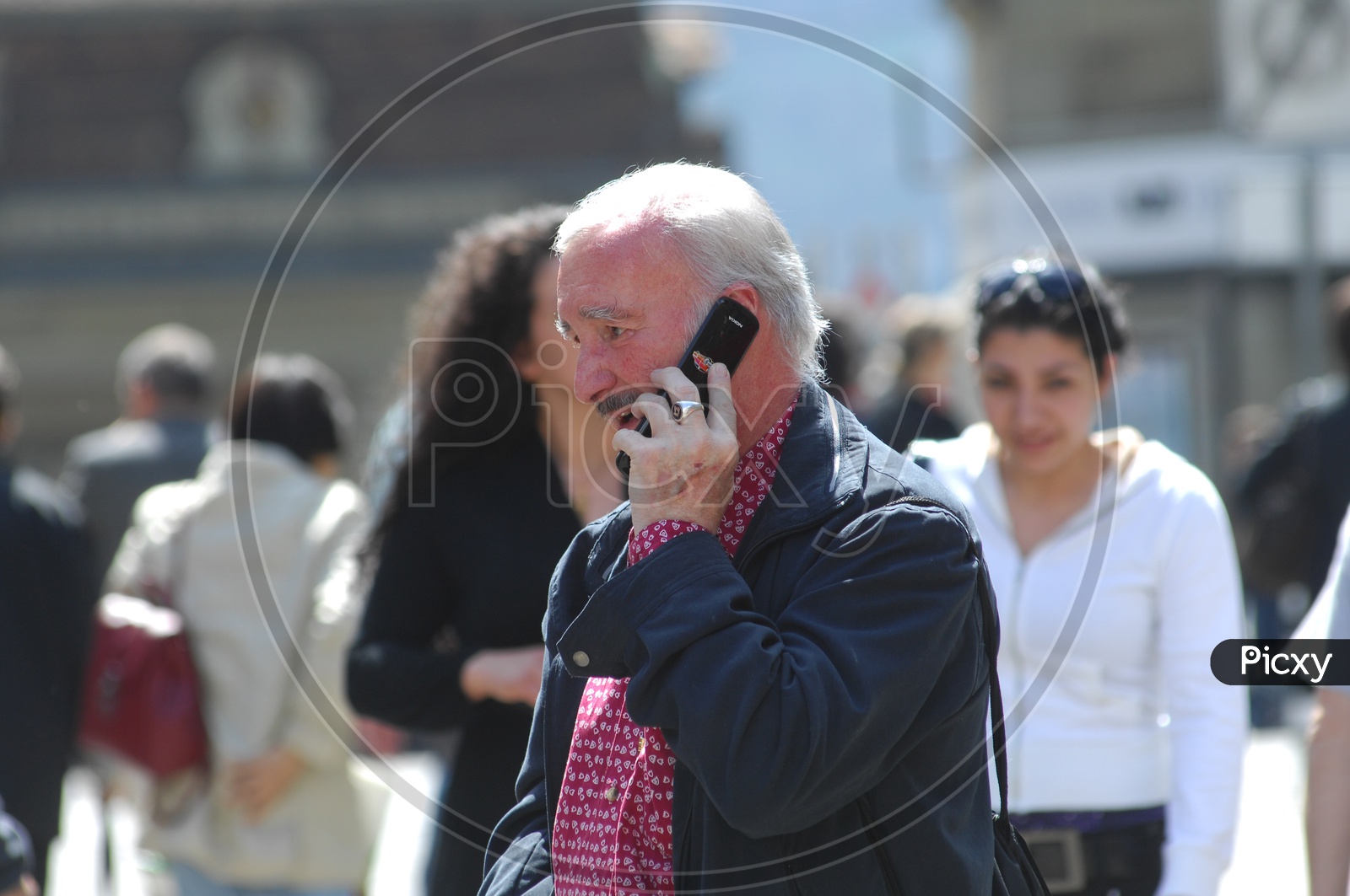 An old man taking over a phone