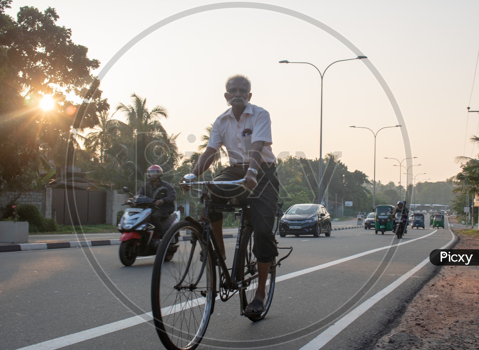 An Old Man Commuting In a Bicycle  on Roads Of Sri Lanka