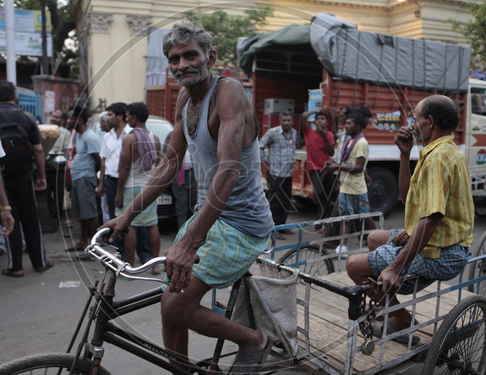 An old man pedaling the rickshaw