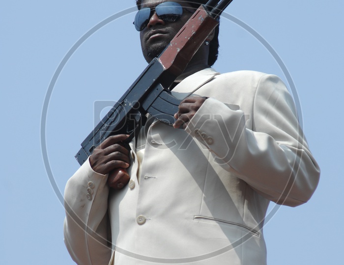A man with a gun and suit - Movie Still