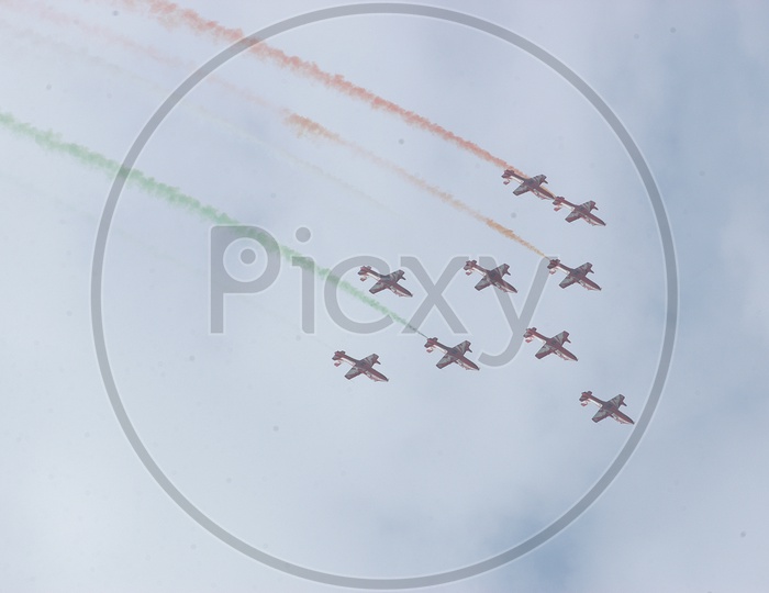 Group of jet planes flying in air with tri-colour art
