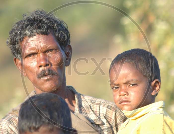 Tribal Man With Children in Village