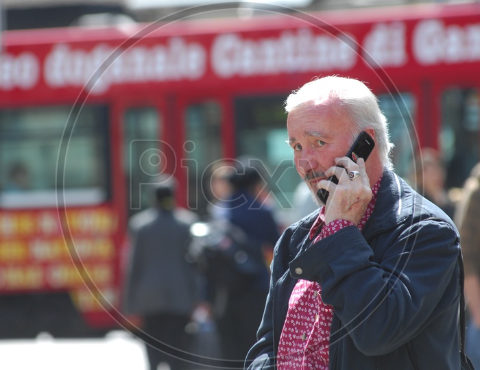 An old man taking over a phone