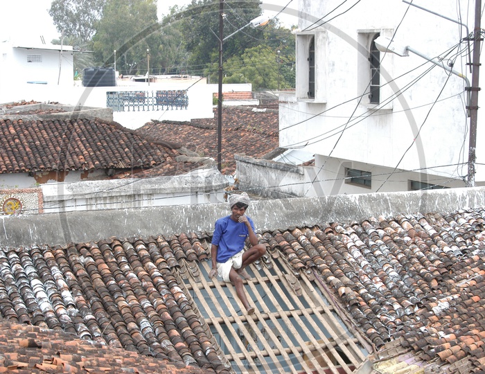 A Man Working On His House Roof Ceiling