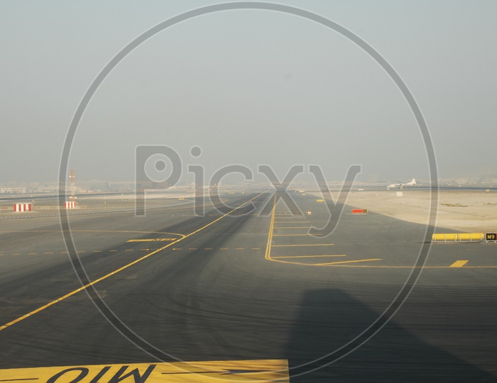 Dubai international Airport runway from flight window