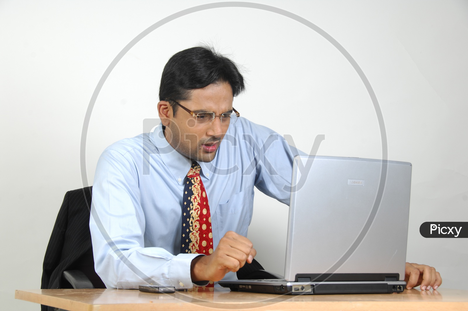 Young Indian Man working on a  Laptop