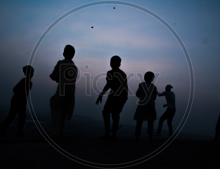 Silhouete of Children Flying Kites in Pushkar