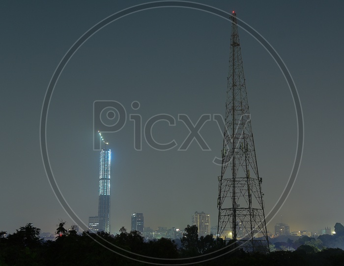 A View Of a Building in Night Time With a Cellular Tower Composition Shot