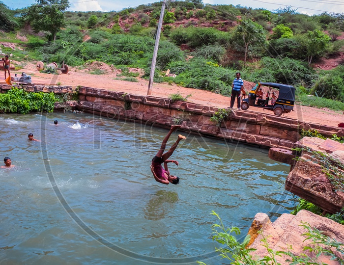Village lads swimming near Mahakoota