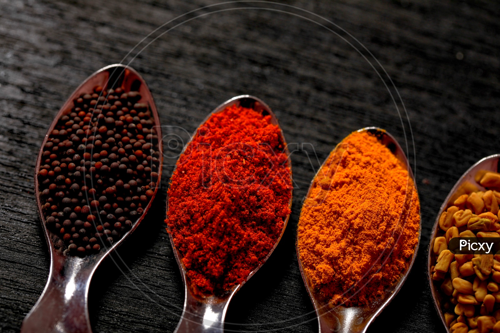 Various Indian Spices In Spoon On an Black Background