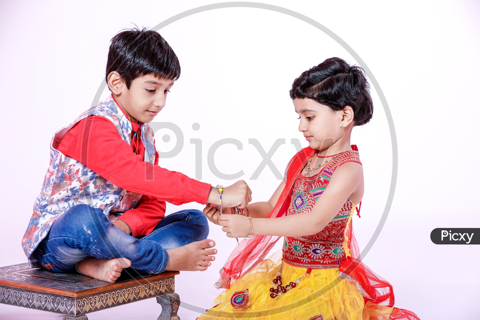 cute Indian brother and sister celebrating raksha bandhan festival