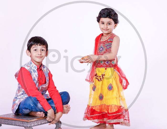 cute Indian brother and sister celebrating raksha bandhan festival