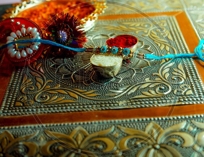 Blue Rakhi with Kumkum & rice -  Indian Festival traditions/rituals