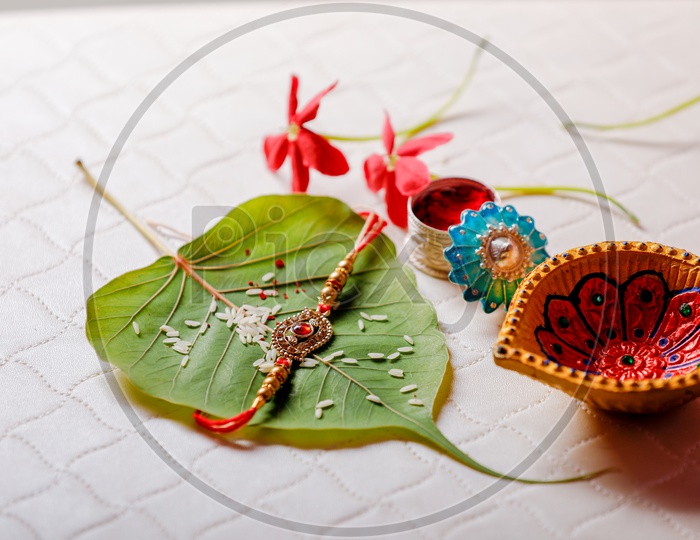 Rakhi on betel leaf with Diya - Indian Festival traditions/rituals