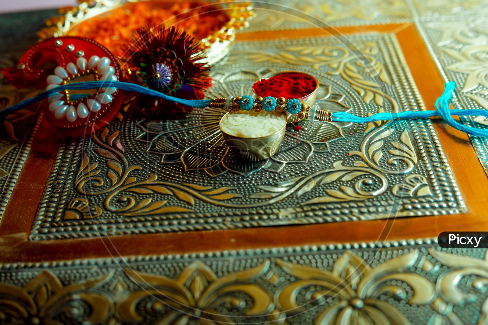 Blue Rakhi with Kumkum & rice -  Indian Festival traditions/rituals