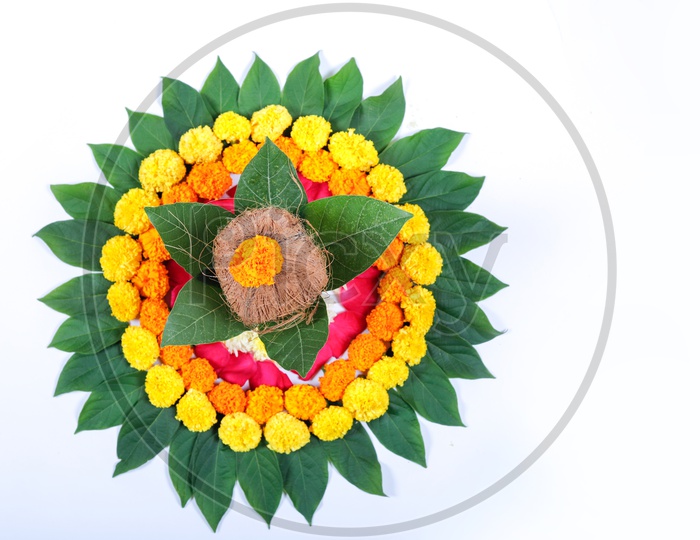 Copper Kalash with Coconut, Leaf and Floral Decoration on a white background.