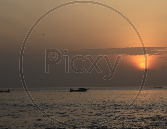 Sunset/Sunrise with boats along the Bay of Bengal Sea
