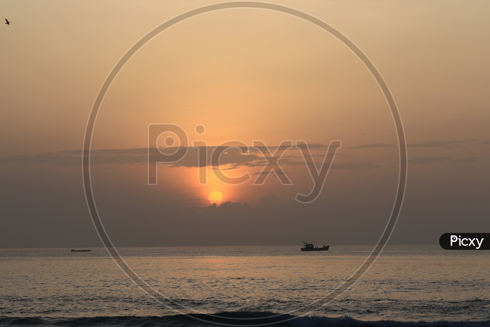 Sunset/Sunrise with a boat along the Bay of Bengal Sea