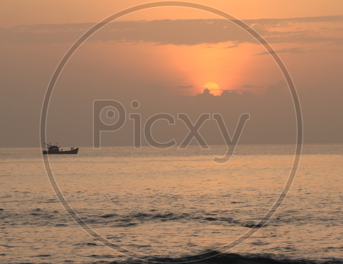 Sunset/Sunrise with a boat along the Bay of Bengal Sea