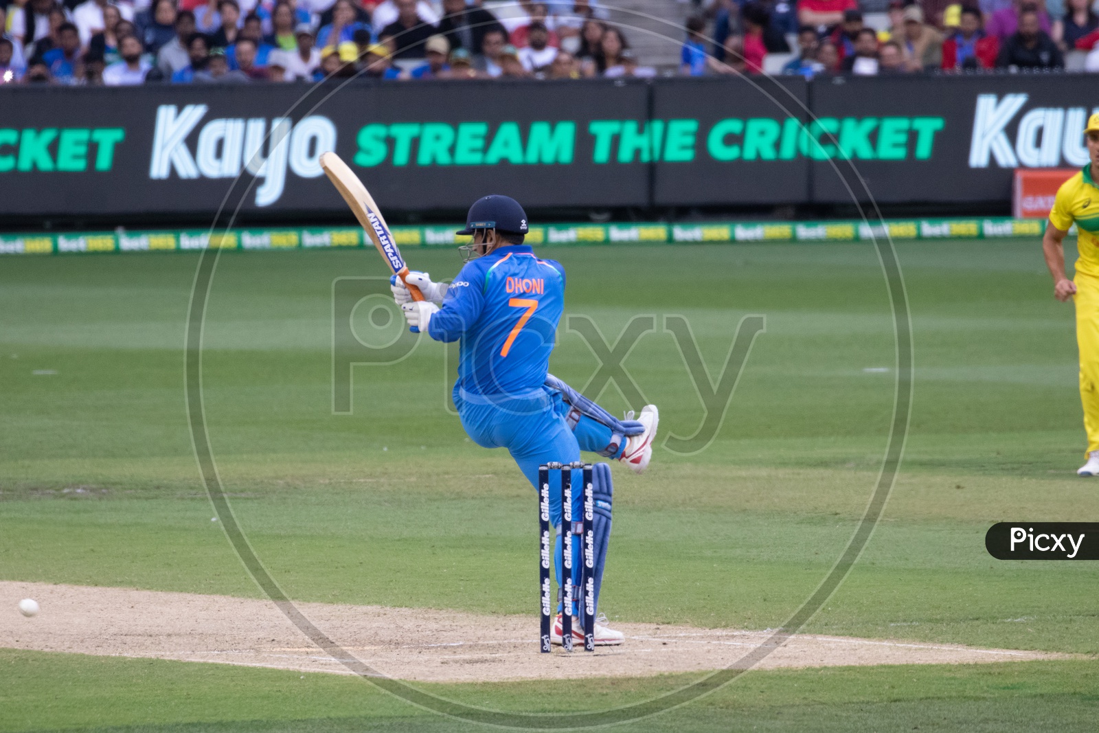 MS Dhoni on a Cricket Stadium Playing a Shot In a Match
