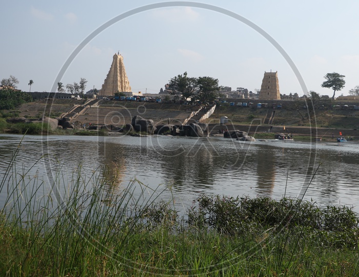 A Reflection Of Temple Shrine  Of Historic Virupaksha Temple on Pond Water  in Hampi ,  Karnataka