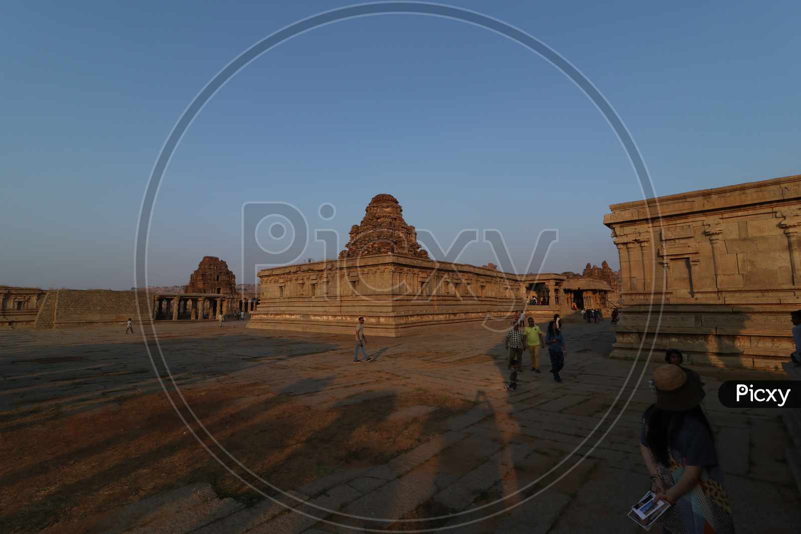 Tourists / Visitors At an  Old Ancient Dravidian Vitthala Temple in Hampi , Karnataka
