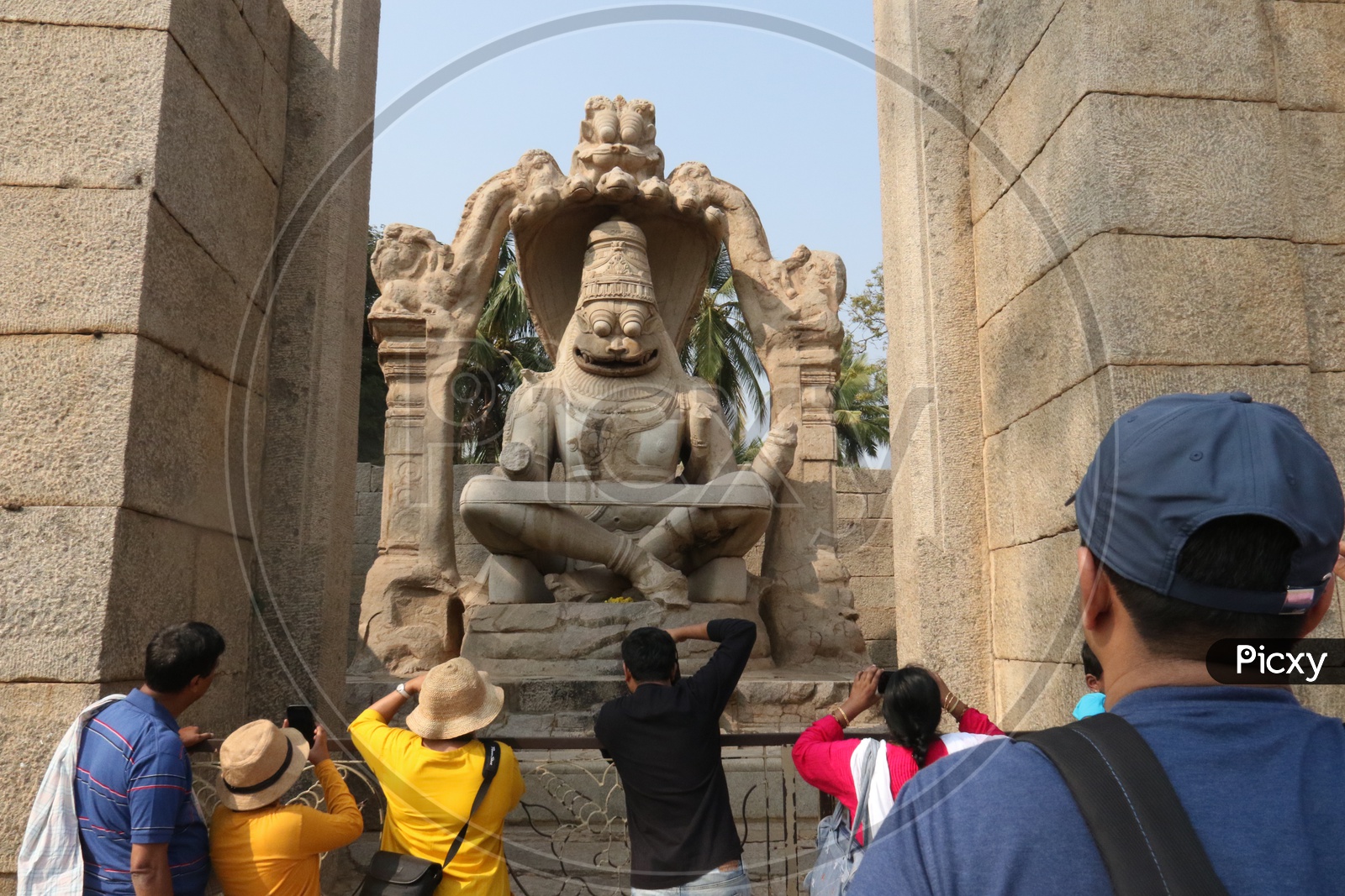 Visitors / Tourists At The Lakshmi Narasimha temple In Hampi , Karnataka