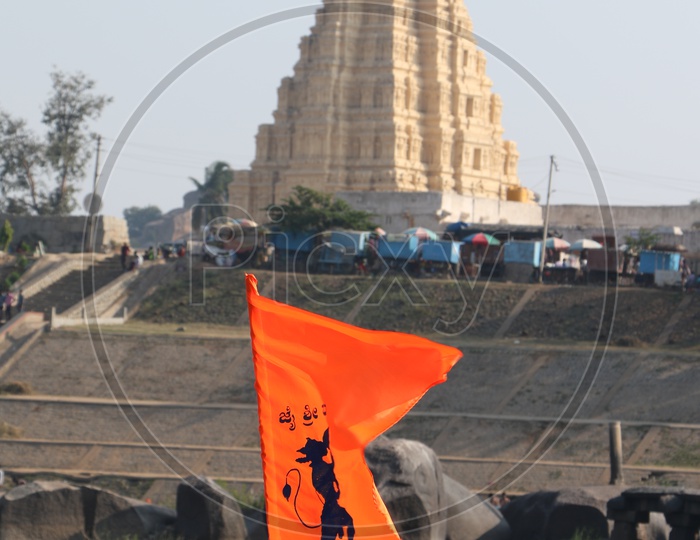 Saffron Flags Of Hindu God Hanuman With Backdrop as Virupaksha Temple In Hampi  ,  Karnataka