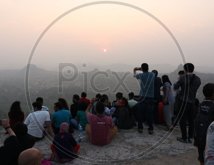 Visitors / Tourists Watching Sunset on Rock hills Of Hampi