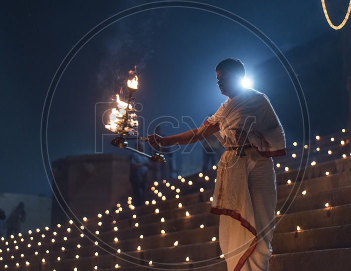 A hindu Priest Performing a Aarti / harathi for ganga river in varanasi