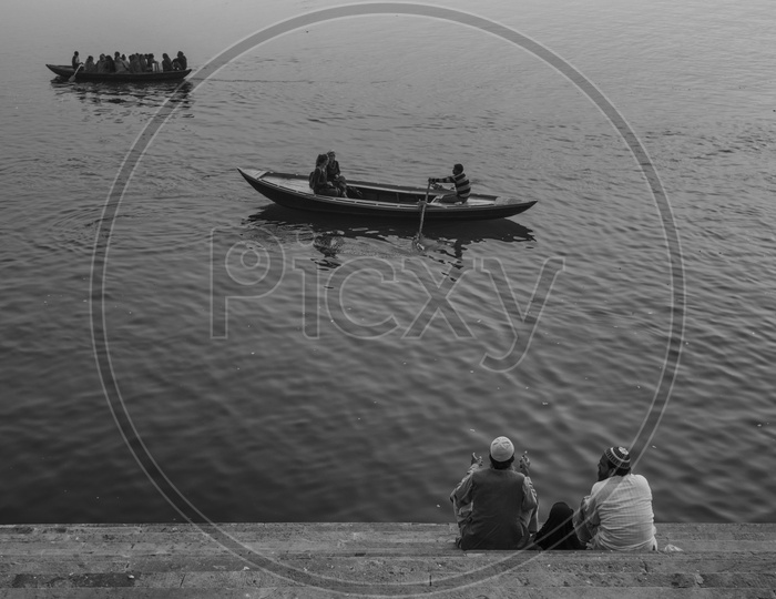 Two muslim Friends Sitting On the Stairs Of Ganga River bank in varanasi