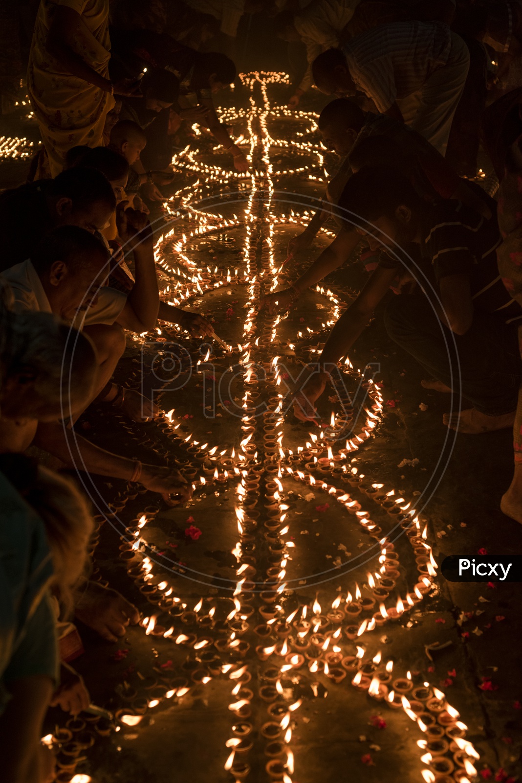 Indian hindu Devotees lighting Dias in Varanasi