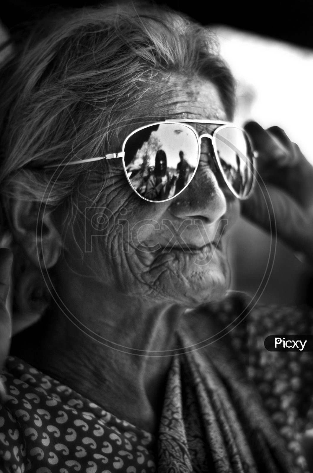 An old lady wearing sunglasses