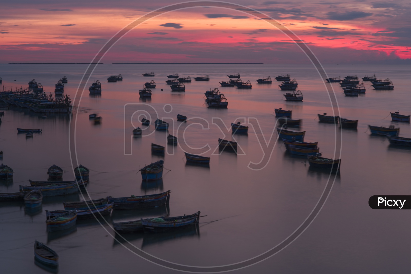 A Silhouette of  Fishing Boats over a Sunset