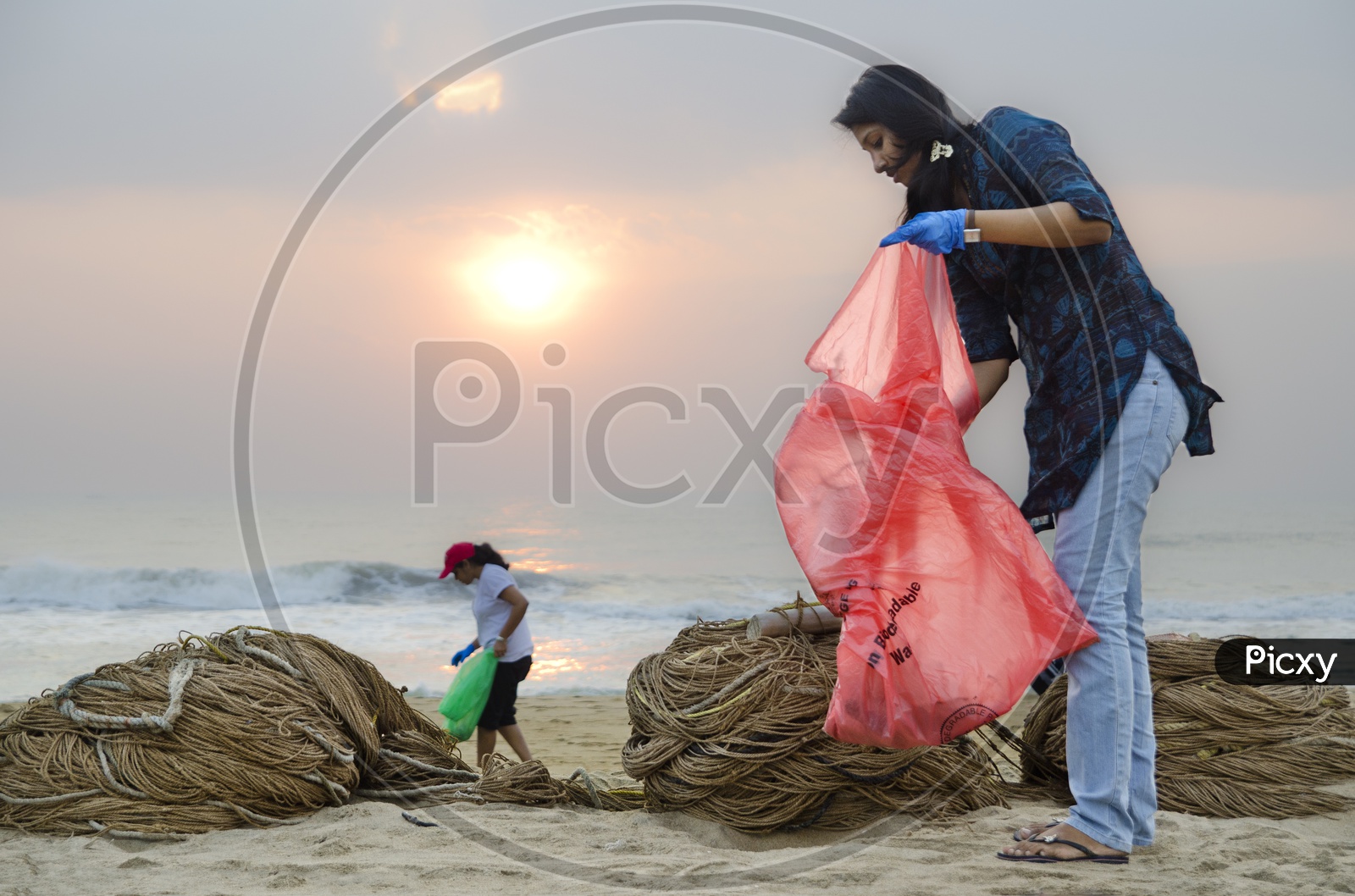 Girls helping to keep the beach clean