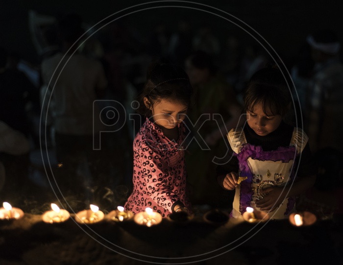 Girl Children Lighting Dias on River Banks of Varanasi