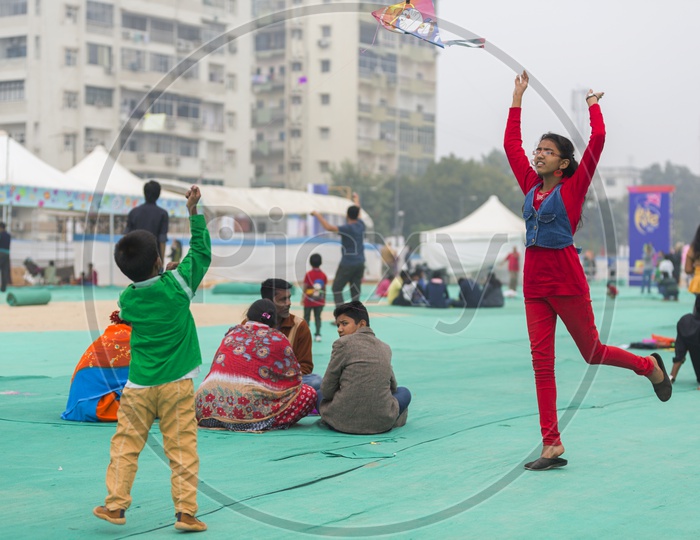 Indian Children Playing With Kites in a Kite Festival